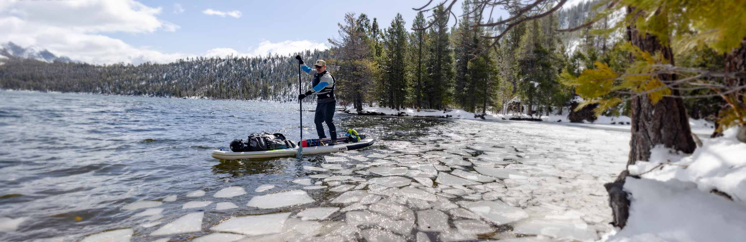 NRS SUP paddler on icy waters, prepared for the 5 Golden Rules of Cold Shock