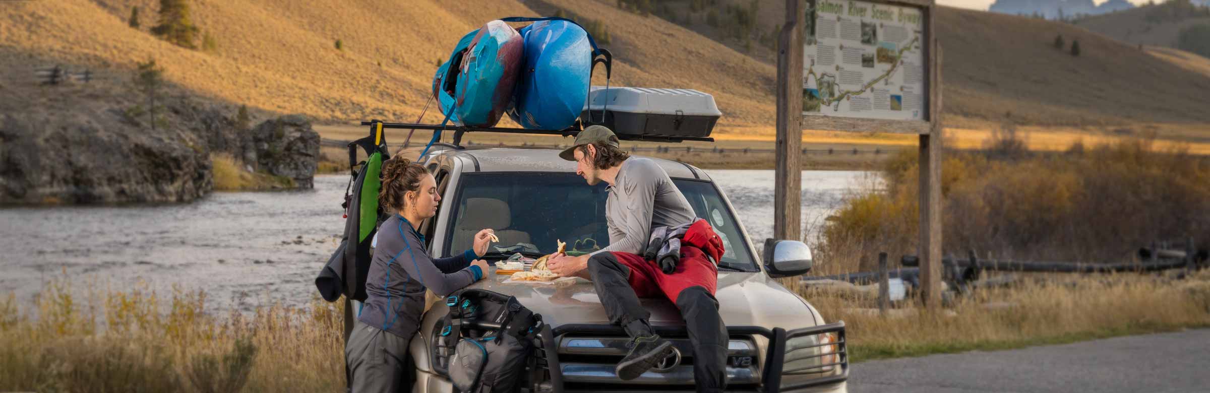 Kayaks strapped to a car roof rack with NRS Straps.