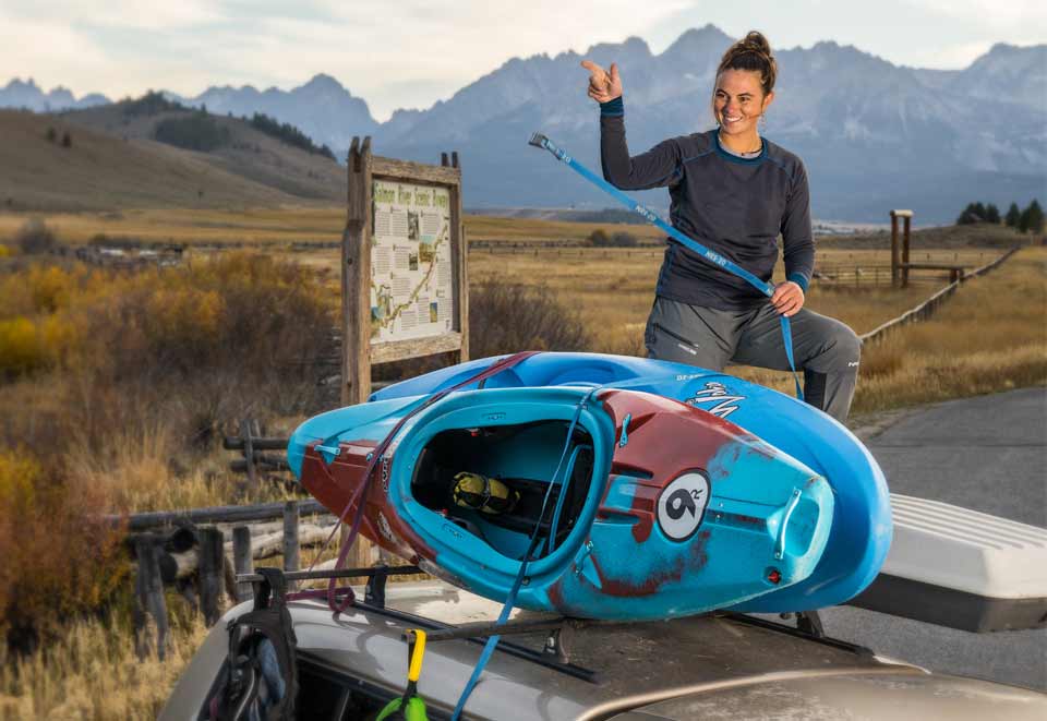 Two kayaks secured on a roof rack using NRS Straps.