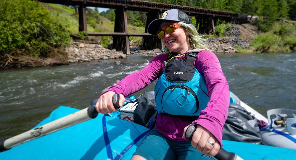 Rowing a river raft.