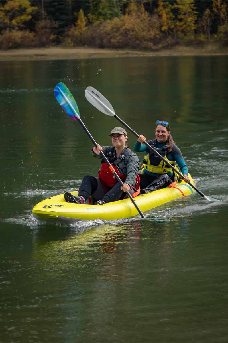Two happy paddlers float downriver in the Kaholo 145 inflatable kayak.