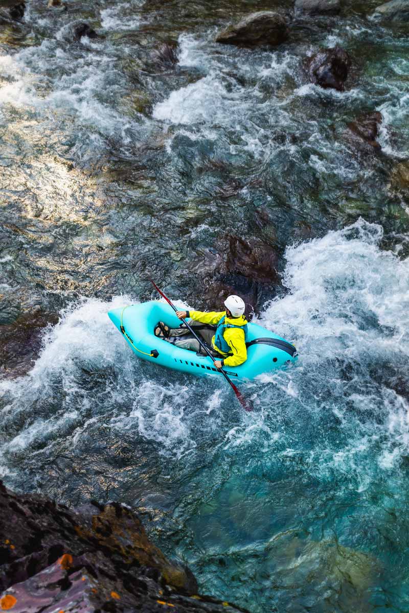 A paddler navigates whitewater rapids in the Pulsar Packraft.